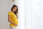 pregnant woman in yellow shirt.